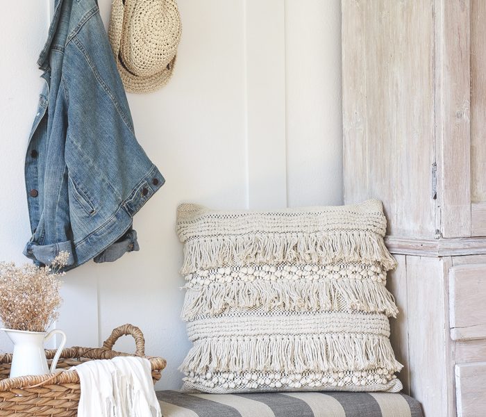 This beautiful farmhouse entryway is the perfect mix of style and organization with a cozy bench, hooks for coat storage, and a basket for accessories.