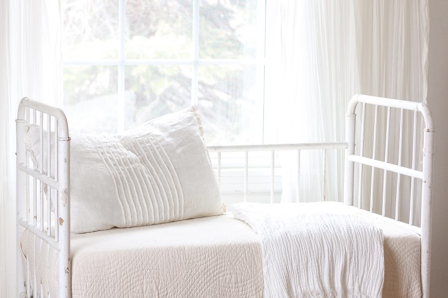 Home and lifestyle blogger Liz Fourez turns a wooden antique crib into an adorable bench with a quilted cushion.