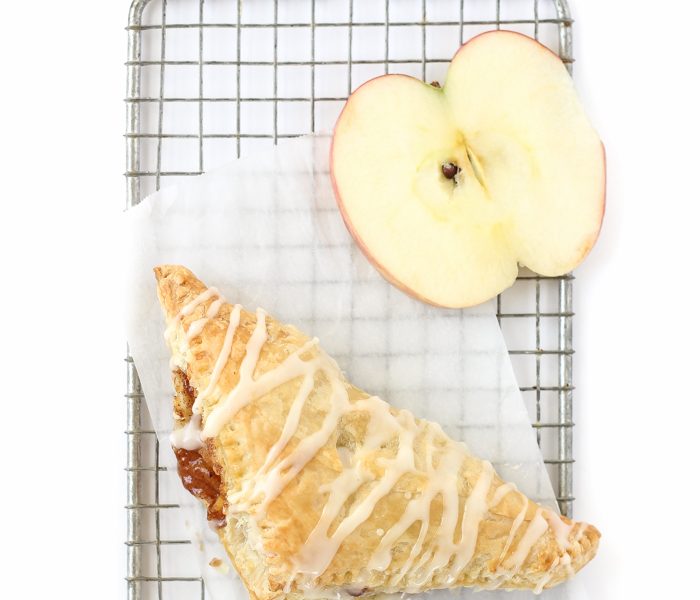 Delicious apple turnovers with a flaky pastry crust, apple cinnamon filling, and sweet vanilla glaze