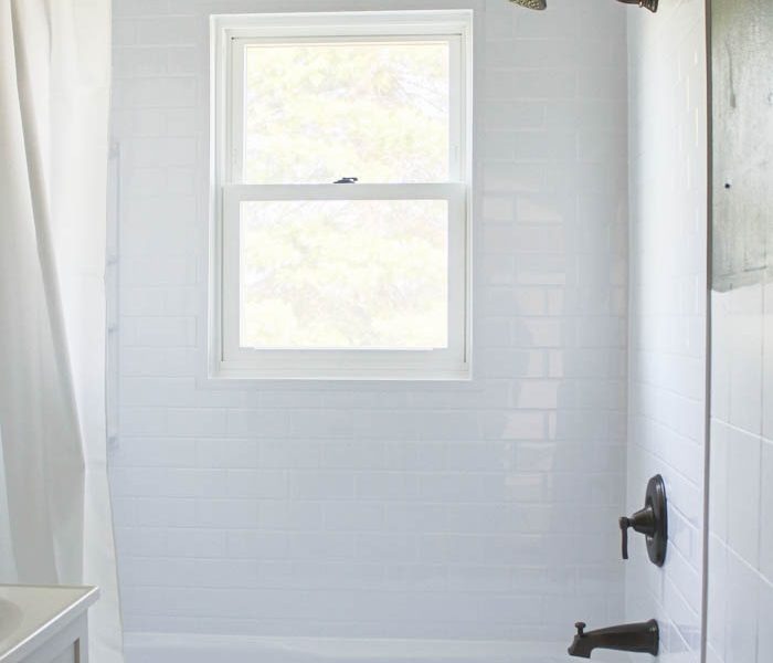 Follow along the big makeover of LoveGrowsWild.com's bathroom! In this post, Liz shares the bathtub and shower installation. Click to see more!