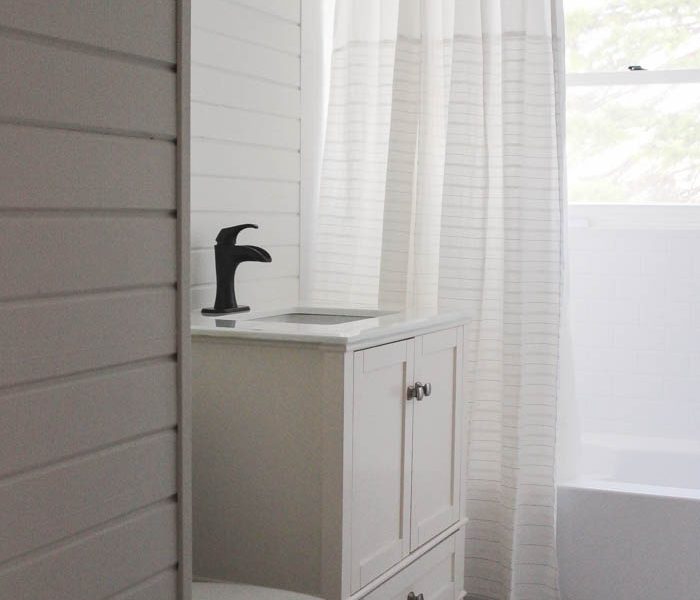 Follow along the big makeover of this beautiful farmhouse bathroom! In this post, Liz reveals her new planked walls, vanity, and closet! Click to see more photos at LoveGrowsWild.com