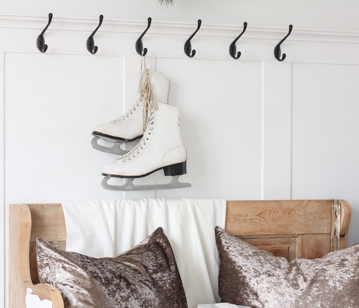 A simple winter white entryway decorated for the holidays in a beautiful farmhouse