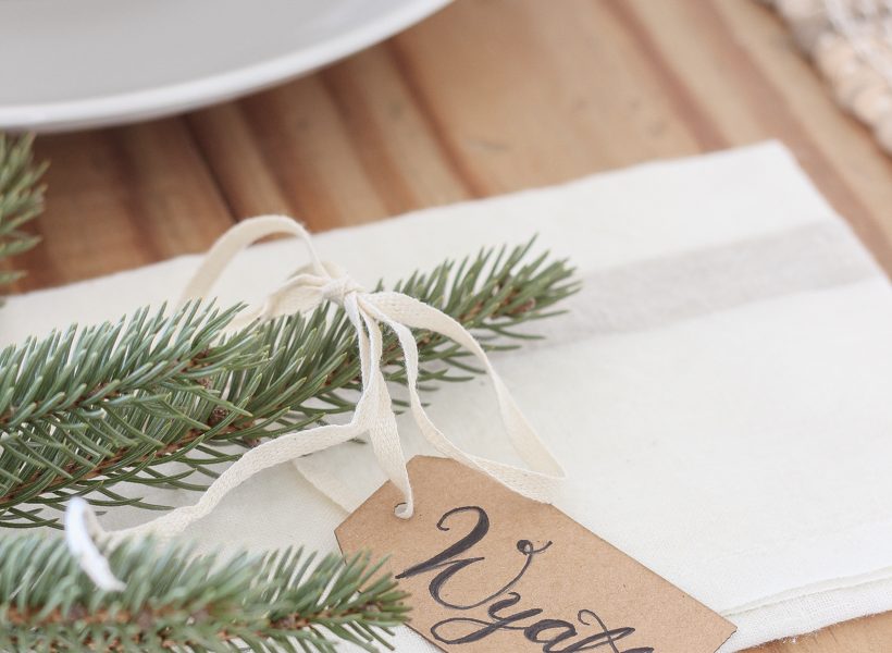 A simple, no fuss Christmas tablescape with fresh greens and beautiful antique metal accents