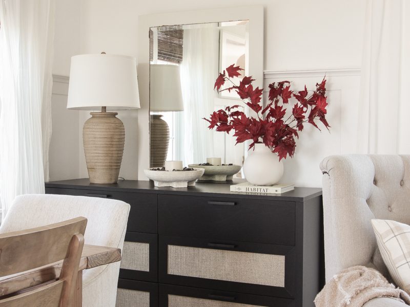 Home blogger and interior decorator Liz Fourez shares a beautiful fall vignette in her dining room featuring deep red fall branches and a new furniture find that has a high-end look without the high-end price