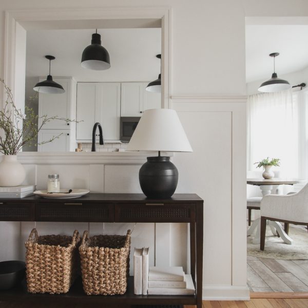 A beautiful dark wood console table styled in the home of blogger and interior decorator Liz Fourez