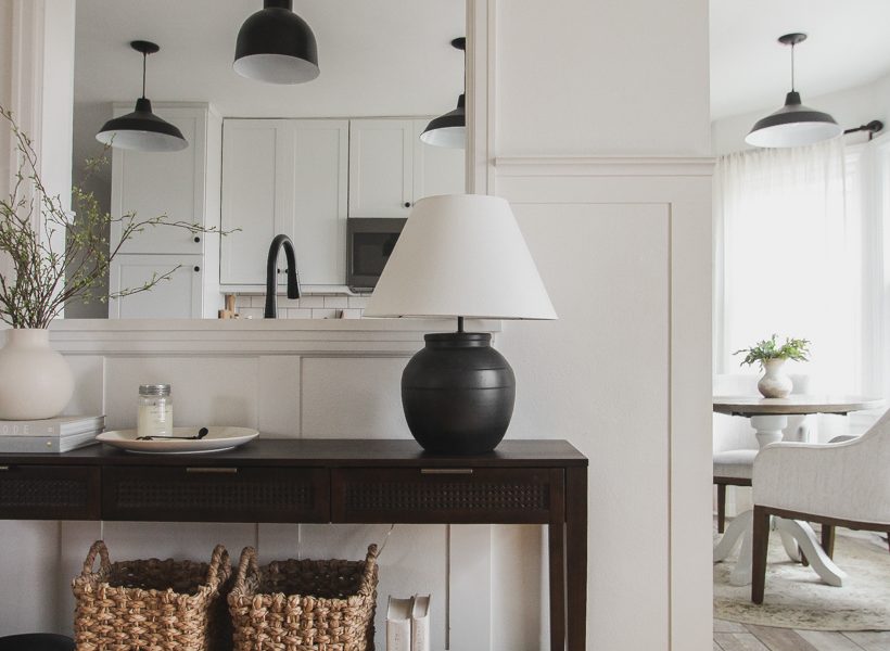 A beautiful dark wood console table styled in the home of blogger and interior decorator Liz Fourez