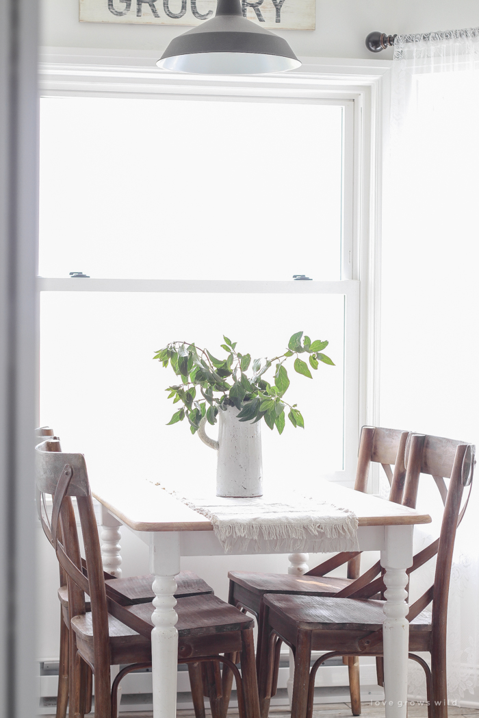 Touches of lace and other feminine fabrics soften this beautiful farmhouse for easy summer style.