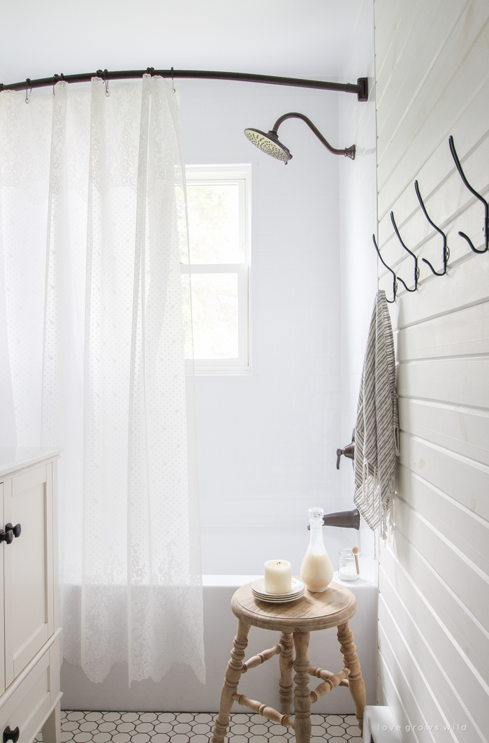 Touches of lace and other feminine fabrics soften this beautiful farmhouse for easy summer style.