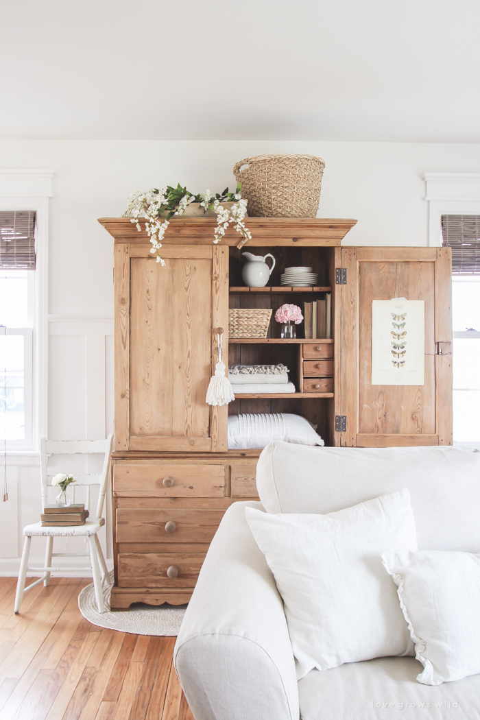 A gorgeous antique armoire decorated for spring in a lovely, little farmhouse. See more photos at LoveGrowsWild.com