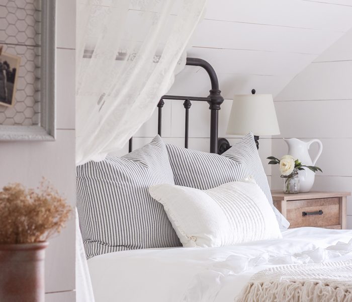 A clean and cozy farmhouse master bedroom with tons of vintage charm