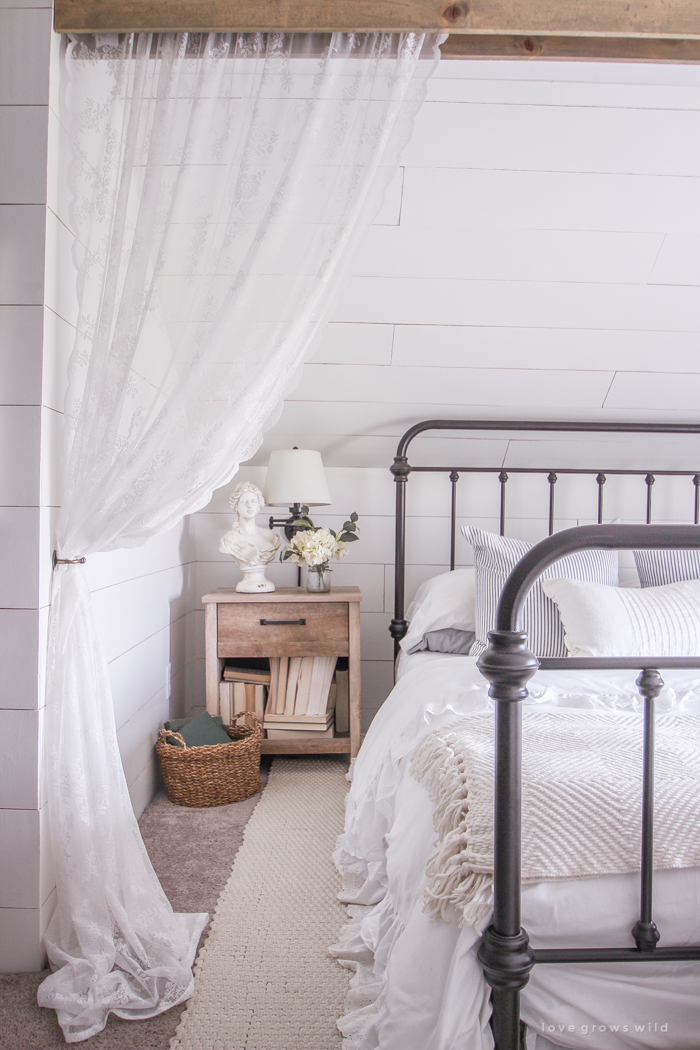 A clean and cozy farmhouse master bedroom with tons of vintage charm